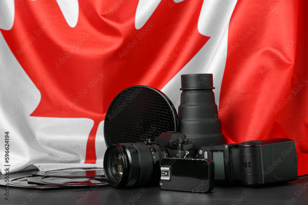 Photographer's equipment on table against flag of Canada Stock Photo | Adobe  Stock