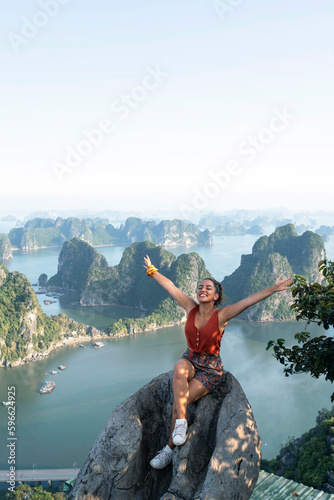 A beautiful young woman travels to Southeast Asia to enjoy stunning views of Halong Bay in Vietnam