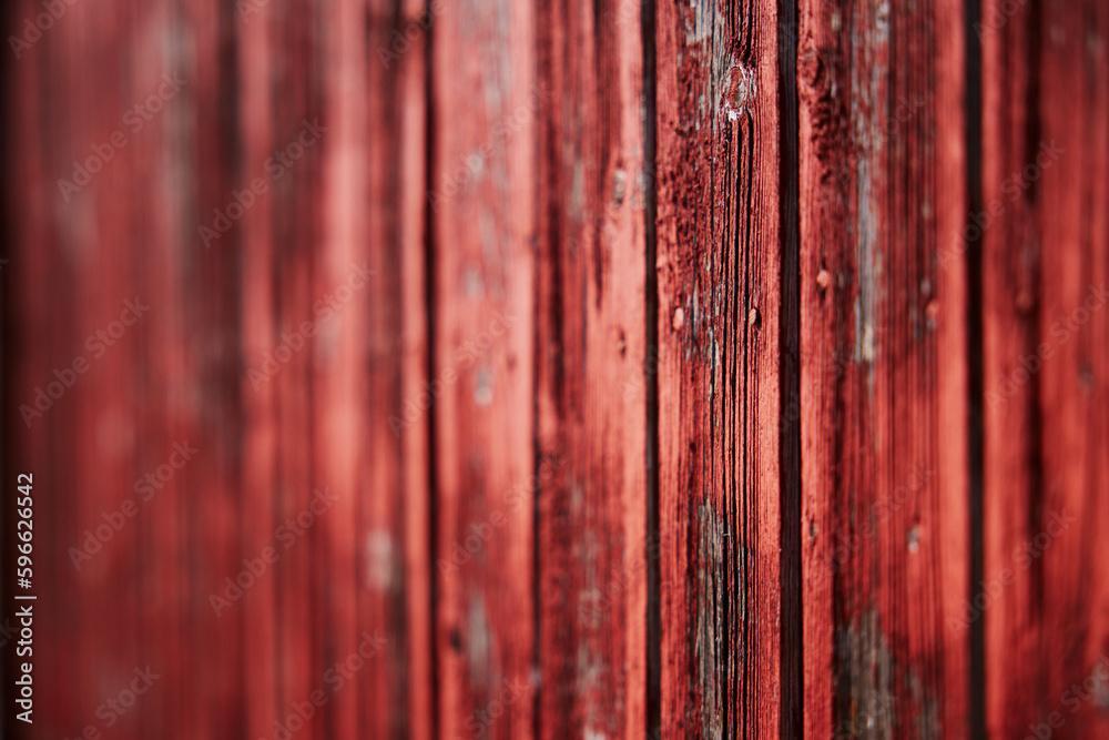 Naklejka premium old red barn wood panel red paint texture that is flaking off low depth of field