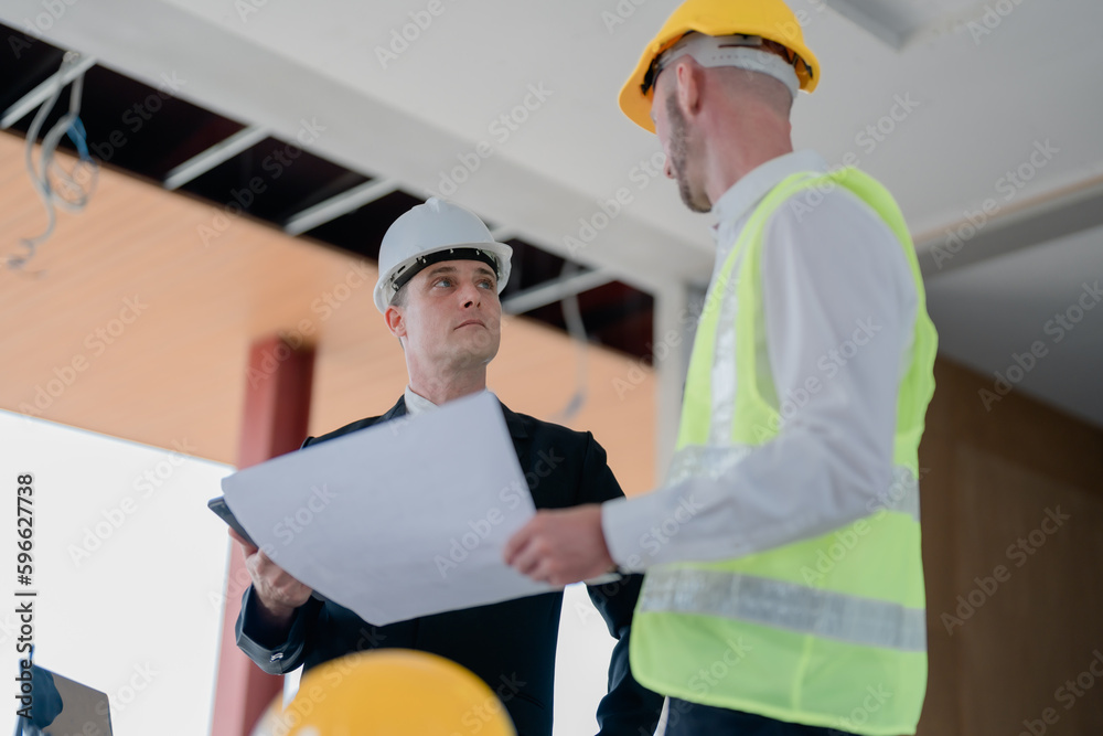 multi ethnic engineer brainstorming and measuring for cost estimating on blueprint and floor plan drawings about design architectural and engineering for houses and buildings multi ethnic engineer brainstorming and measuring for cost estimating on blueprint and floor plan drawings about design architectural and engineering for houses and buildings