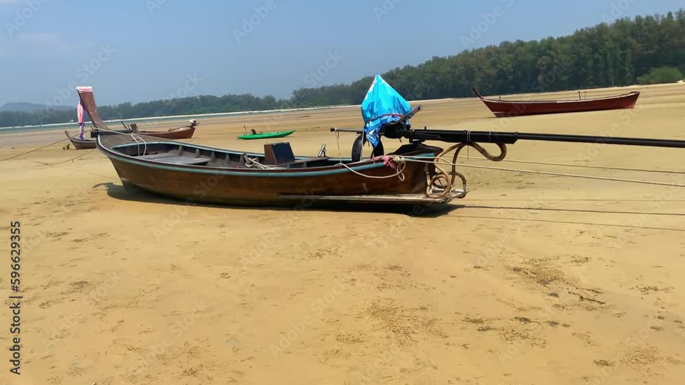 Large wooden boat stands on a huge beach on the sand. Large wooden boat stands on a huge beach on the sand.