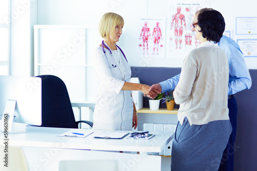 friendly female medical doctor talking with patient.