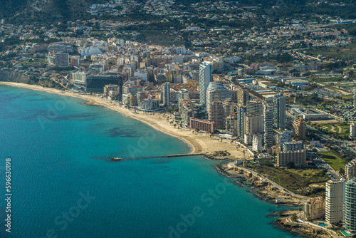 modern apartments, Cantal Roig beach and sailboats and fishing boats in the port of Calpe. Top view, horizontal