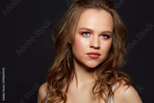 Beautiful woman's face with tan. clean skin - isolated on black.