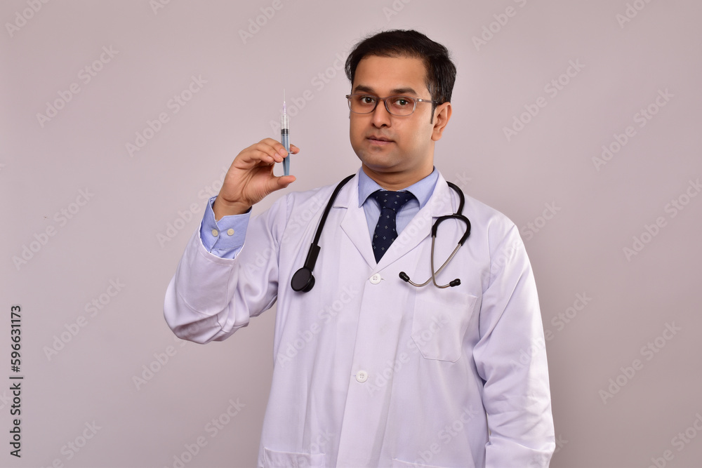 Young Indian Male Doctor with syringe Young Indian Male Doctor with syringe