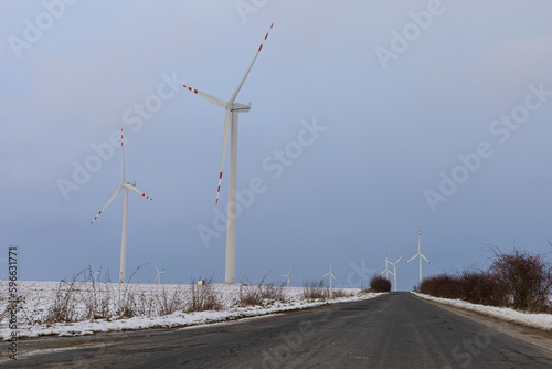 windmills near the asphalt road in winter
