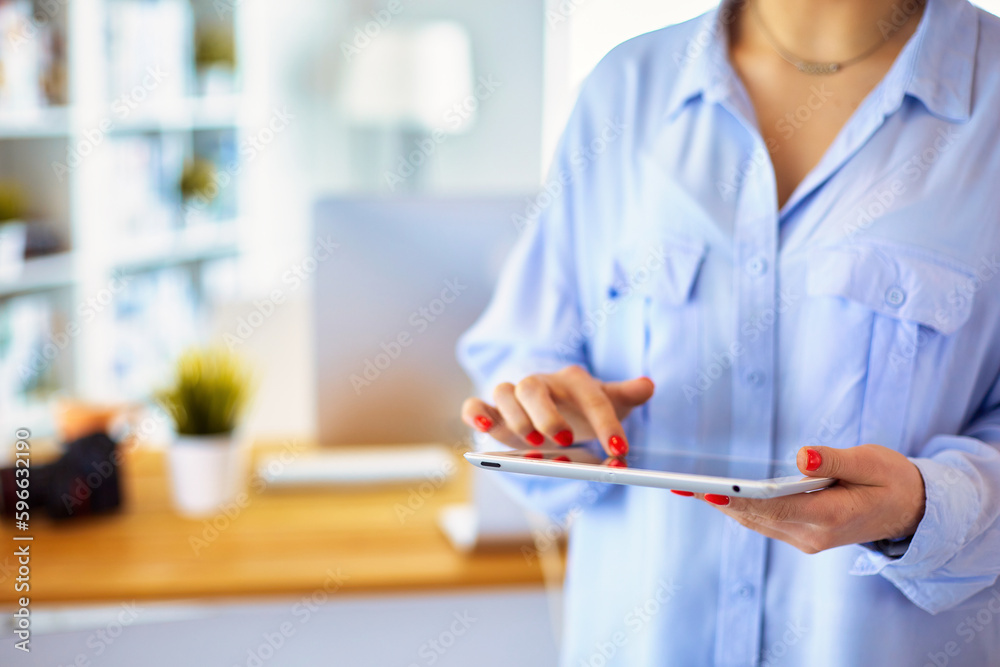 Portrait of an attractive professional photographer woman and using a tablet. Portrait of an attractive professional photographer woman and using a tablet.