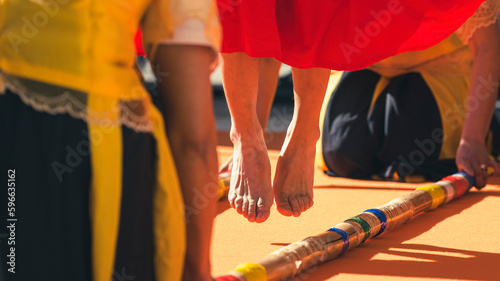 Jumping feet performing Tinikling, probably the most popular folk dance in the Philippines. The dancer imitates the movements of the bird by skillfully maneuvering between two large bamboo piles. photo