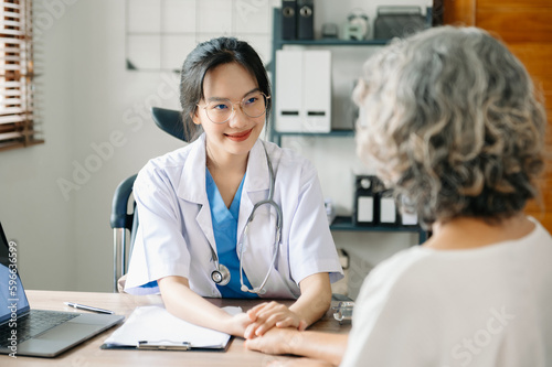 A professional physician talks to discuss results or symptoms and gives a recommendation to a male patient and signs a medical paper at an appointment visit in the clinic..