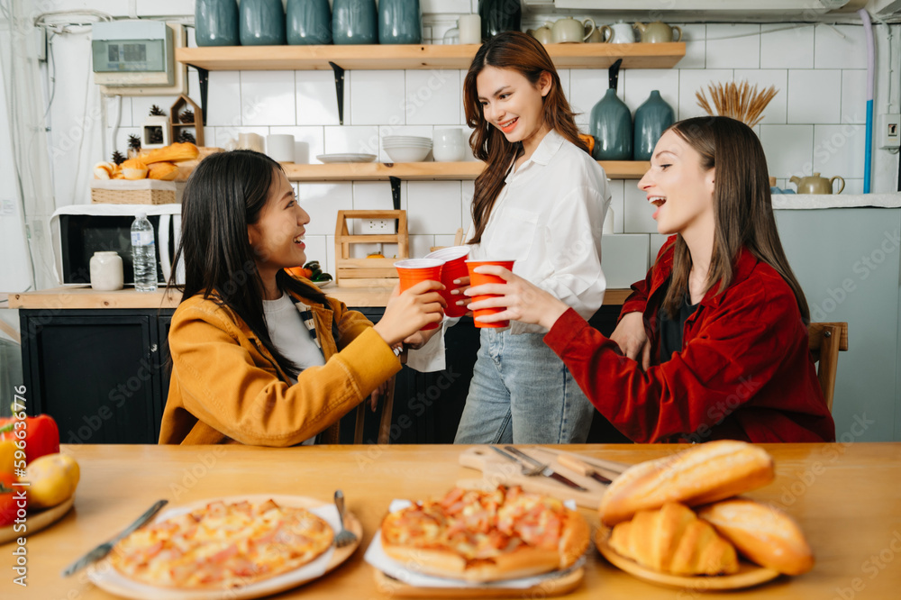 Group of friends making fun at home party.They sitting on desk in living room and eating pizza. happy Group of friends making fun at home party.They sitting on desk in living room and eating pizza. happy