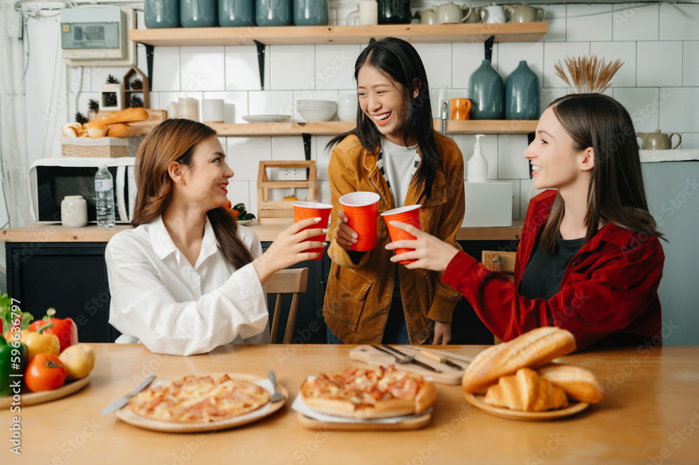 Group of friends making fun at home party.They sitting on desk in living room and eating pizza. happy Group of friends making fun at home party.They sitting on desk in living room and eating pizza. happy