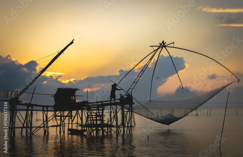 Fishermen are catching fish in the sea. by using flattery in Phatthalung Province, Thailand