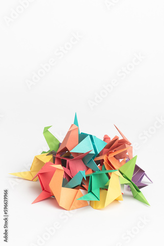 Creativity makes life more colourful. Studio shot of a pile of colourful origami birds.