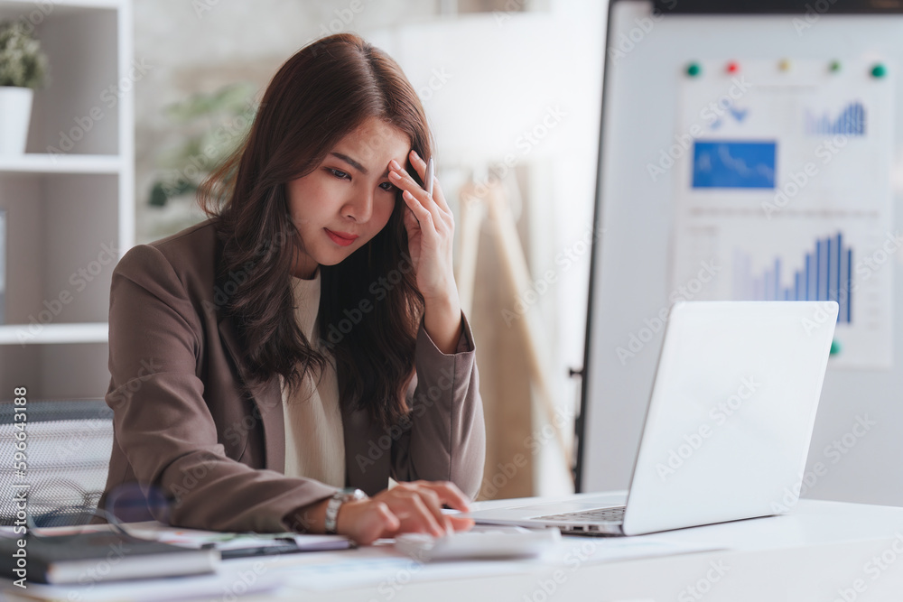 Accountant woman working on laptop and do document look stress, tax, exchange, research, accounting and Financial advisor concept Accountant woman working on laptop and do document look stress, tax, exchange, research, accounting and Financial advisor concept