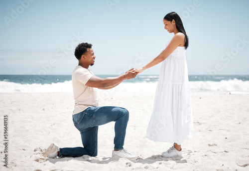 My always, my forever. Shot of a young man proposing to his girlfriend at the beach.