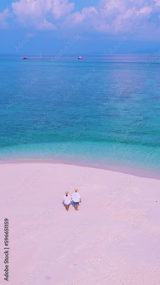 couple of men and women on the beach of Ko Lipe Island Thailand couple of men and women on the beach of Ko Lipe Island Thailand