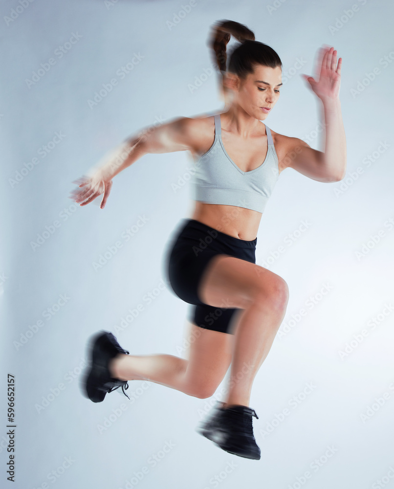 Time to level up. Full length shot of an attractive young female athlete posing in studio against a grey background. Time to level up. Full length shot of an attractive young female athlete posing in studio against a grey background.