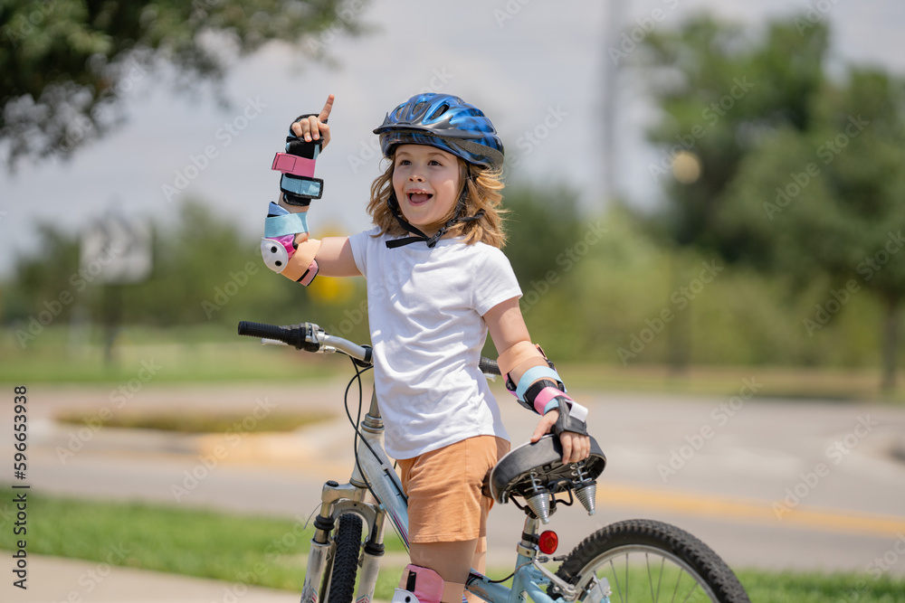 Kid learning to ride bike. Child riding bicycle. Little kid boy in helmet on bicycle along bikeway. Happy cute little boy riding bicycle. Child in the protective helmet for bike cycling on bicycle. Kid learning to ride bike. Child riding bicycle. Little kid boy in helmet on bicycle along bikeway. Happy cute little boy riding bicycle. Child in the protective helmet for bike cycling on bicycle.