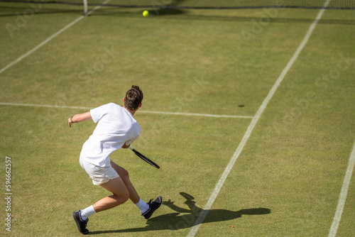 Amateur playing tennis at a tournament and match on grass in Europe  photo