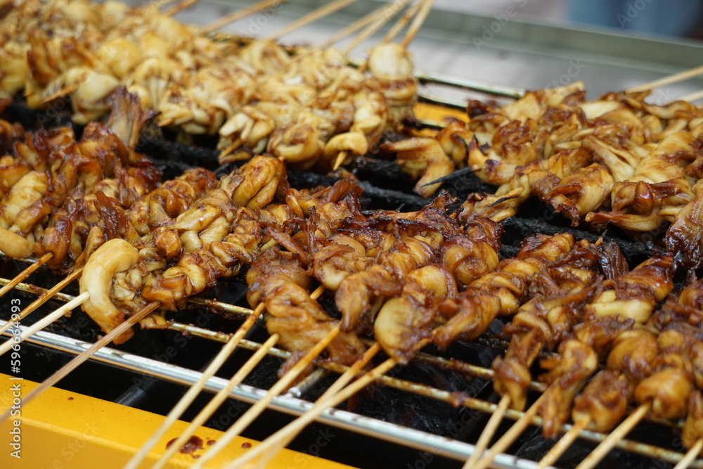 Mushroom satay on grilled process. Sate is one of indonesian famous food Mushroom satay on grilled process. Sate is one of indonesian famous food