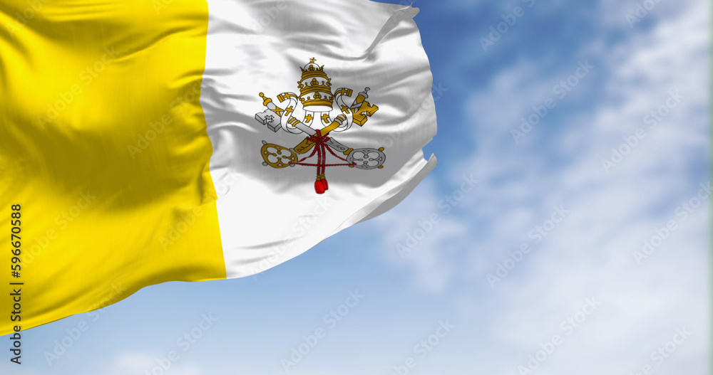 Φωτογραφία Flag of Vatican City waving in the wind on a clear day