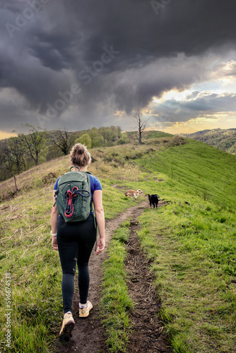 Young woman hiking in the mountains of the French Basque Country with their Border Collie photo