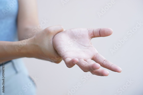 Asian woman having hand numbness photo