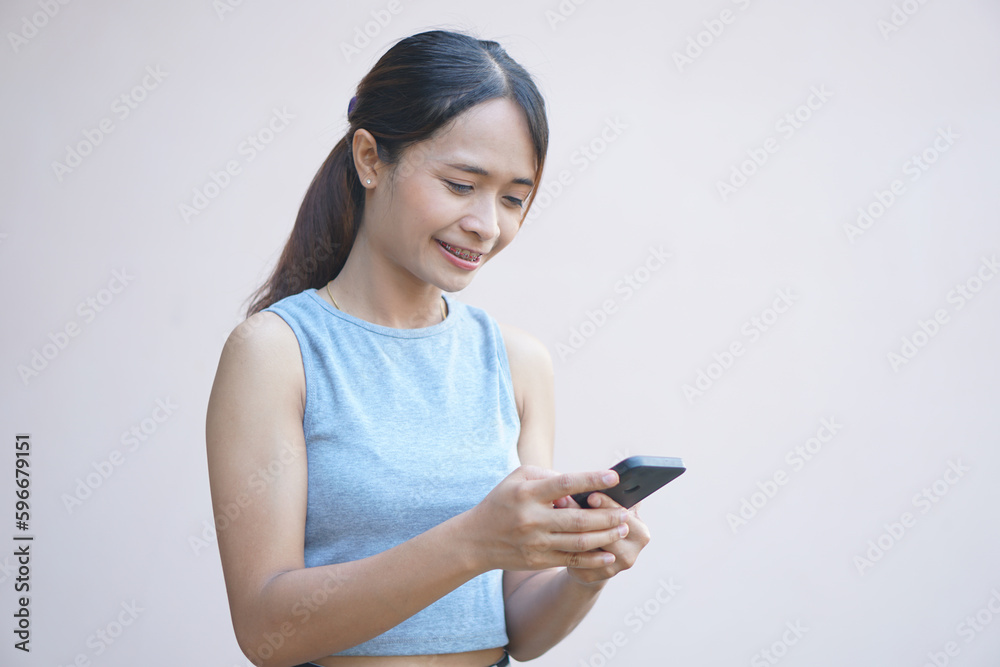Woman looks at phone and rejoices from more business profit Woman looks at phone and rejoices from more business profit