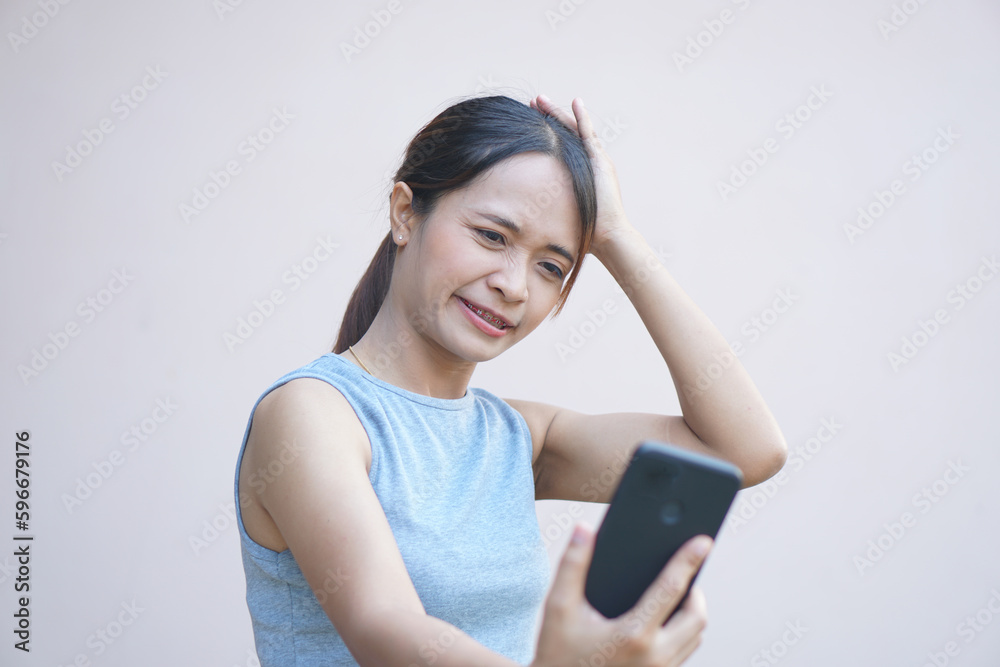 Woman looks at phone and rejoices from more business profit Woman looks at phone and rejoices from more business profit