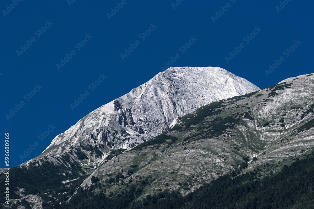 Mt. Vihren summit against clear blue sky viewed from Mt. Todorka. Summer mountain landscape in Bansko ski resort, Bulgaria.