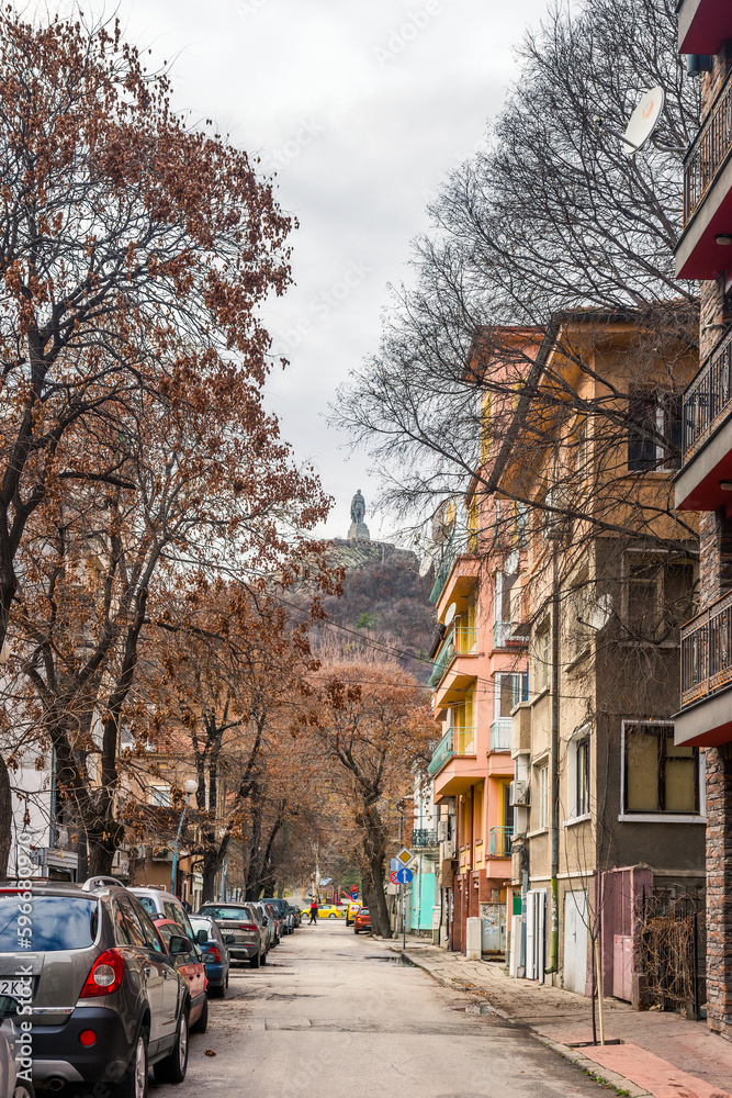 PLOVDIV, BULGARIA - 11.01.2023 A street with the Aliosha monument on the top of Bunardzhik hill on the horizon.