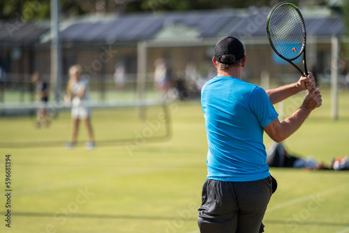 Amateur Tennis player, playing tennis at a tournament and match on grass in Europe 