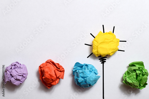 Creative thinking ideas and innovation concept. Paper scrap ball yellow colour with light bulb symbol