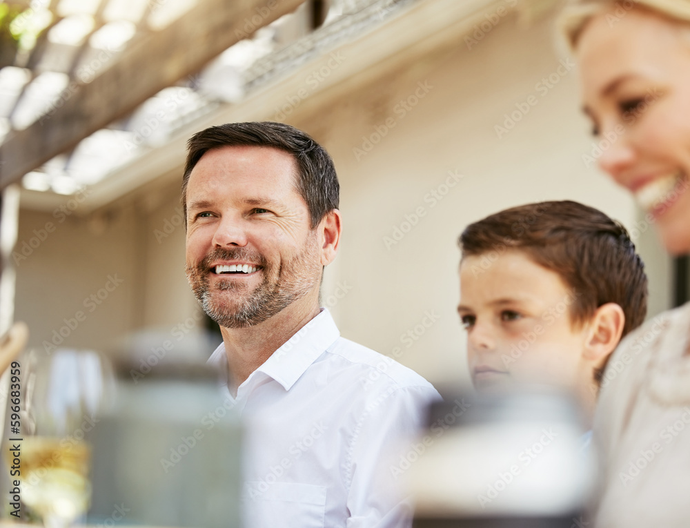 Fototapeta premium Happy, fed and relaxed. Shot of a family enjoying a meal together.