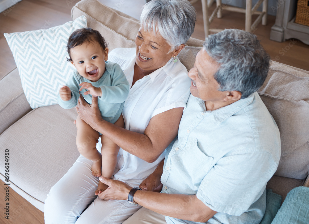 Obraz premium Such a sweet baby. Shot of grandparents bonding with their grandchild on a sofa at home.