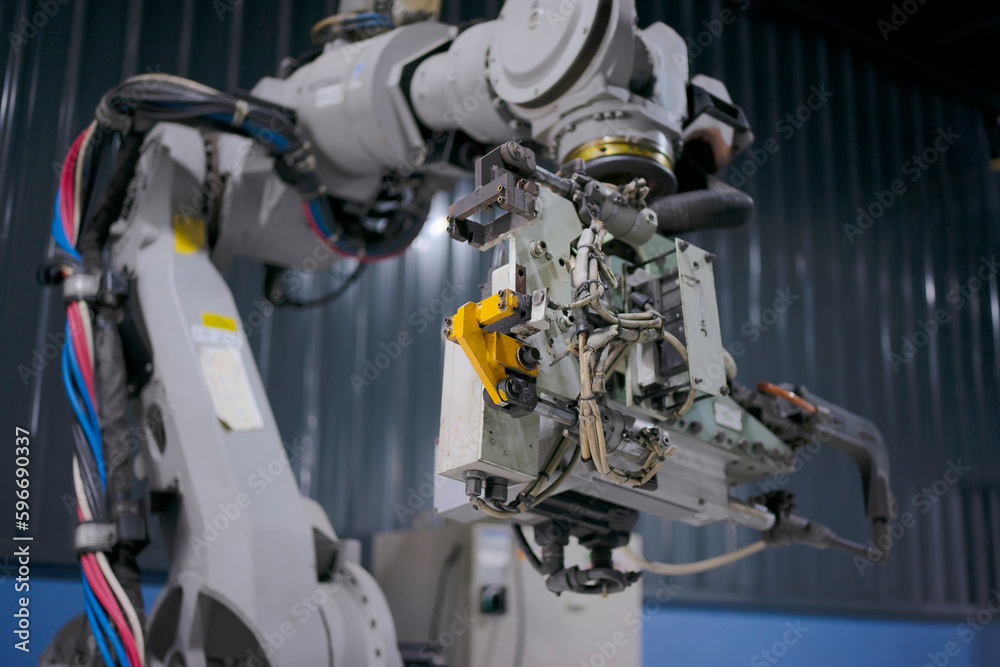 Engineer work at robotic arm factory.
