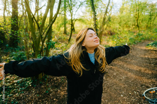 Quadro em tela Attractive caucasian woman breathe fresh air , enjoying springtime on a sunset i