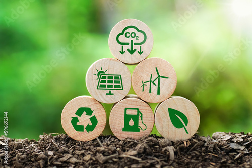 Reduction of carbon emissions, carbon neutral concept. Net zero greenhouse gas emissions target. Reducing carbon footprint concept. Decreasing CO2 emissions target symbol on wooden cube, natural green