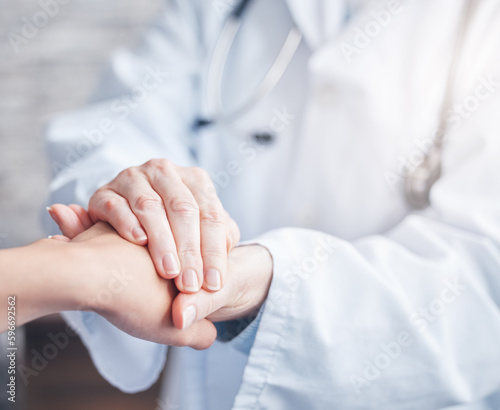 I am going to support you every step of the way. Closeup shot of an unrecognisable doctor holding a patients hand in comfort.