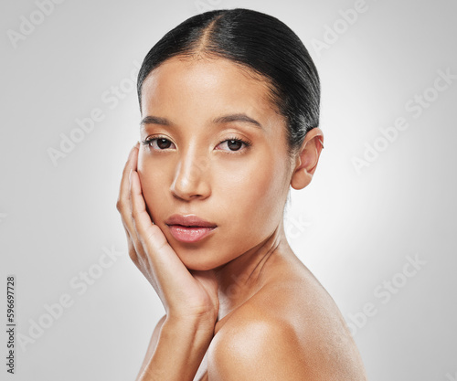 Start with glowing skin. Studio portrait of an attractive young woman posing against a grey background.