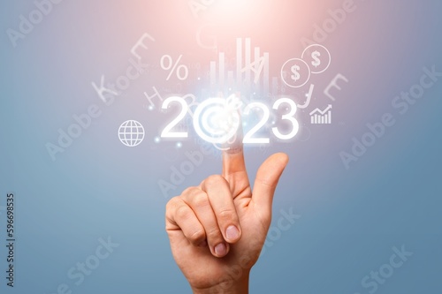 2023 concept, business person hold numbers with target