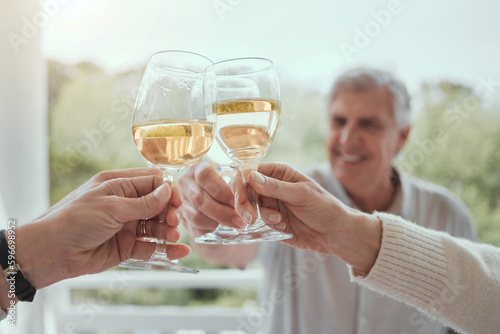 Growing up, I learned lifes important lessons at dinner. Shot of an elderly man toasting with unrecognizable family memers at home. photo
