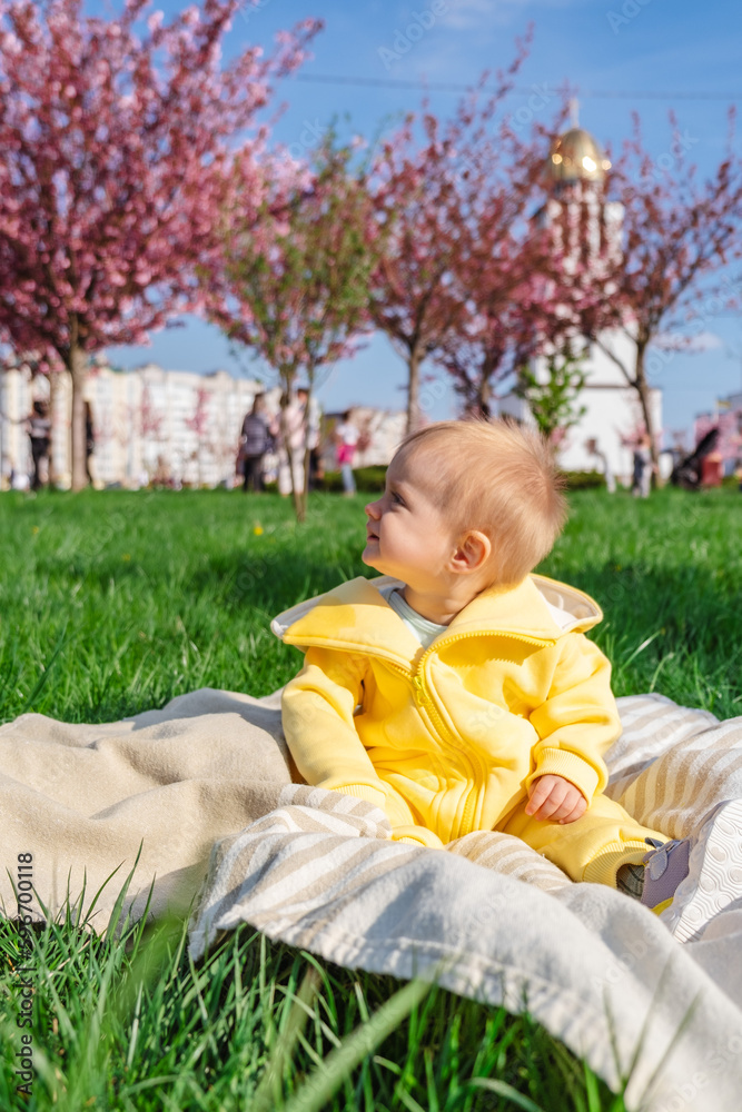 Adorable one-year-old boy in yellow overalls enjoying the outdoors Adorable one-year-old boy in yellow overalls enjoying the outdoors