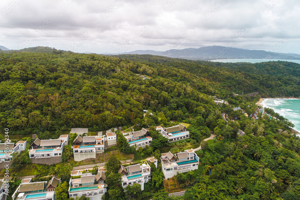 Aerial sea island with villa resort hotel in tropical rainforest