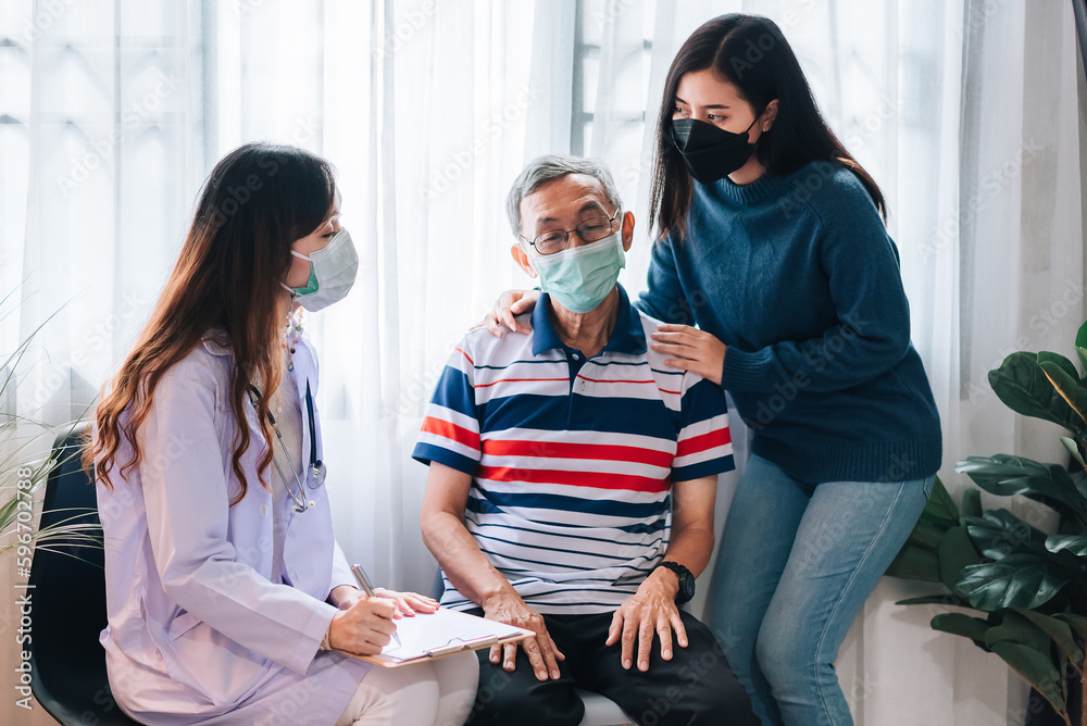 Asian doctor visit and examines a senior man at home ,The doctor checking up and consulting for retirement health partient,hospital services ,and wearing a mask to protect covid-19.