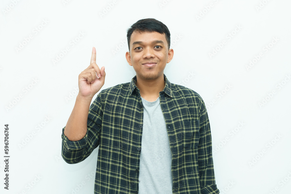Young Asian man smiling happy and showing one index finger up Young Asian man smiling happy and showing one index finger up