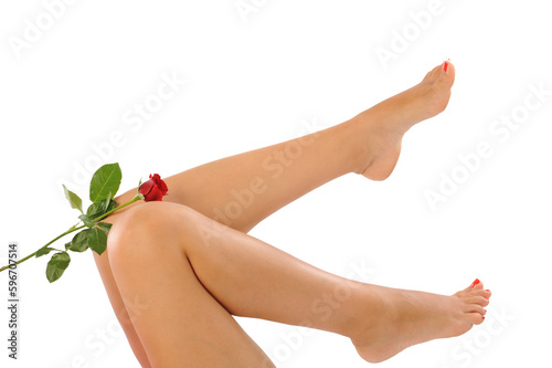 female legs of a beautiful woman with flower petals isolated in white background