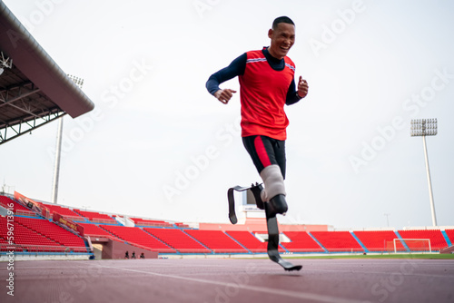 athlete runner physically disabled run on track of stadium © FotoArtist