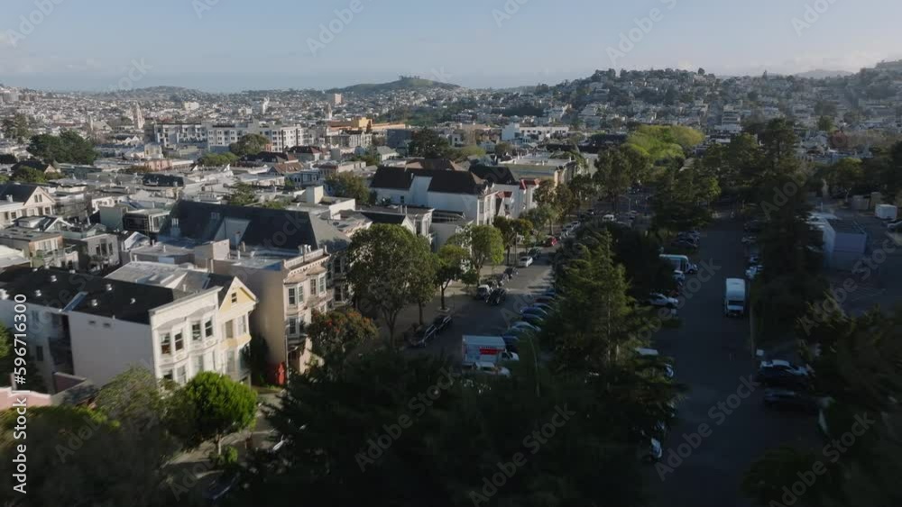 Forwards fly above dense town development in residential urban borough. Buildings and streets in city at golden hour. Forwards fly above dense town development in residential urban borough. Buildings and streets in city at golden hour.