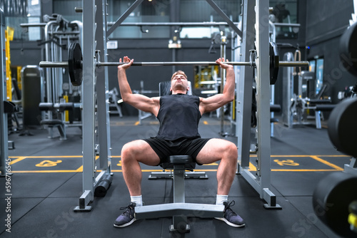 Man doing weight lifting exercises inside the gym